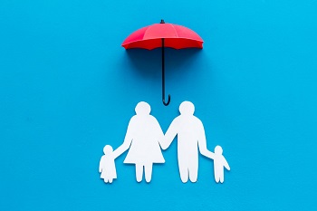 Sillhouette of family under umbrella.
