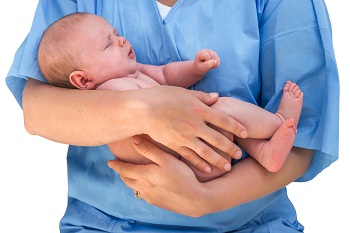 Doctor holding a beautiful newborn baby isolated od white background